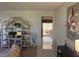 A bright hallway view leading to a lanai, complemented by a decorative shelving unit at 14132 89Th Ave, Seminole, FL 33776