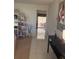 Hallway with tiled floors and view to the lanai with an arched shelving unit on the left at 14132 89Th Ave, Seminole, FL 33776