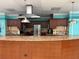 A kitchen with stainless steel appliances, wood cabinets, and a large island counter at 14132 89Th Ave, Seminole, FL 33776