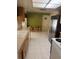 Functional kitchen with white appliances, tiled floor, a dining area, and ample counter space at 14132 89Th Ave, Seminole, FL 33776