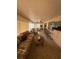 Spacious sun room featuring multiple seating areas, a bar, ceiling fan, and ample natural light at 14132 89Th Ave, Seminole, FL 33776