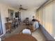 Comfortable sun room with ceiling fan, multiple seating options, and sun-filtering vertical blinds at 14132 89Th Ave, Seminole, FL 33776