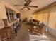 Cozy sun room featuring comfortable seating, a bar area, ceiling fan, and vertical blinds at 14132 89Th Ave, Seminole, FL 33776
