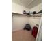 Carpeted walk-in closet with upper shelves and clothing rod at 14132 89Th Ave, Seminole, FL 33776