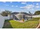 Well-maintained backyard with a screened-in pool, lush lawn and decorative landscaping at 1721 Loriana St, Brandon, FL 33511