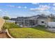 Well-maintained backyard with a screened-in pool, lush lawn and decorative landscaping at 1721 Loriana St, Brandon, FL 33511