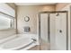 Bright bathroom featuring a soaking tub and a glass-enclosed shower at 1721 Loriana St, Brandon, FL 33511