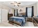 Comfortable bedroom featuring a wooden bedframe, soft carpet, and natural light from the windows at 1721 Loriana St, Brandon, FL 33511
