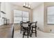 Cozy breakfast nook with seating for four near a bright window and modern lighting at 1721 Loriana St, Brandon, FL 33511