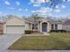 Attractive home with a well-kept lawn, mature landscaping, and a two-car garage at 1721 Loriana St, Brandon, FL 33511