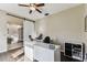 Home office with dark floors, bright white desk and sliding barn door at 1721 Loriana St, Brandon, FL 33511