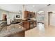Spacious kitchen with granite countertops and stainless steel appliances with seamless flow to living area at 1721 Loriana St, Brandon, FL 33511