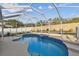 Beautiful pool with a waterfall feature, surrounded by lush landscaping and a screened enclosure at 1721 Loriana St, Brandon, FL 33511