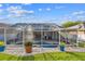 Inviting screened-in pool area surrounded by lush landscaping and a patio at 1721 Loriana St, Brandon, FL 33511