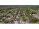 A high aerial view shows a house nestled in a neighborhood surrounded by green trees and a distant lake at 1740 Shady Leaf Dr, Valrico, FL 33596