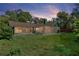 Spacious backyard with a screened-in porch, perfect for enjoying the outdoors and entertaining at 1740 Shady Leaf Dr, Valrico, FL 33596