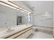 Bathroom with double sinks, large mirror, a shower and separate tiled bathtub at 1740 Shady Leaf Dr, Valrico, FL 33596