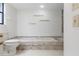 Bathroom featuring a tiled tub with a shower, toilet and unique shelf accents at 1740 Shady Leaf Dr, Valrico, FL 33596