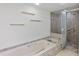 Close-up of tiled bathtub and shower with glass doors, with accent shelving at 1740 Shady Leaf Dr, Valrico, FL 33596