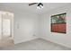 Bedroom with neutral carpet, a window, and a view of the hallway at 1740 Shady Leaf Dr, Valrico, FL 33596