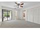 Spacious bedroom with ceiling fan, walk-in closet, and screened porch access at 1740 Shady Leaf Dr, Valrico, FL 33596