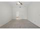 Spacious carpeted bedroom featuring a ceiling fan and a doorway leading to the closet at 1740 Shady Leaf Dr, Valrico, FL 33596