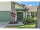 Well-maintained home exterior with stone accents and green door and trim at 1740 Shady Leaf Dr, Valrico, FL 33596