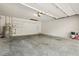 Spacious garage with water heater, storage shelves, and concrete floor at 1740 Shady Leaf Dr, Valrico, FL 33596