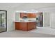 Open-concept kitchen features breakfast bar, modern appliances, and opens to living area at 1740 Shady Leaf Dr, Valrico, FL 33596
