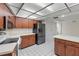 Well-lit kitchen with wood cabinets, stainless steel appliances and tiled flooring at 1740 Shady Leaf Dr, Valrico, FL 33596