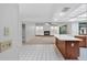 Open kitchen featuring a breakfast bar, white countertops and a view to the living room fireplace at 1740 Shady Leaf Dr, Valrico, FL 33596