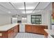 Spacious kitchen features light countertops, wood cabinetry, white appliances and tile flooring at 1740 Shady Leaf Dr, Valrico, FL 33596