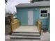 Back porch with freshly painted blue siding and new railings at 2432 Auburn S St, St Petersburg, FL 33712