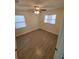 This bright bedroom features wood-look flooring and a ceiling fan at 2432 Auburn S St, St Petersburg, FL 33712