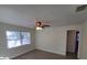 Bright bedroom featuring wood-look flooring, a ceiling fan, and new windows at 2432 Auburn S St, St Petersburg, FL 33712