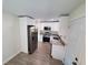 Updated kitchen features stainless steel appliances, granite countertops, and white cabinetry at 2432 Auburn S St, St Petersburg, FL 33712