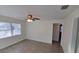 Open-concept living room featuring a ceiling fan, wood-look floors, and neutral paint at 2432 Auburn S St, St Petersburg, FL 33712