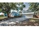 Charming light blue single-story home featuring a two-car garage and well-maintained landscaping at 2580 Redwood Way, Clearwater, FL 33761