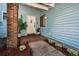 Inviting entryway with a light blue exterior, brick accents, and well-manicured landscaping at 2580 Redwood Way, Clearwater, FL 33761