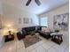 Cozy living room features a modern sectional, neutral walls, and plenty of comfortable seating at 2580 Redwood Way, Clearwater, FL 33761