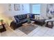 Comfortable living room features a modern sectional, area rug, and lots of natural light at 2580 Redwood Way, Clearwater, FL 33761