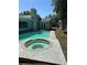 Enjoy a backyard paradise with an in-ground pool, hot tub, and a blue home exterior at 2580 Redwood Way, Clearwater, FL 33761