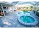 Beautiful pool and spa area with a screened-in enclosure and stylish patio design at 2834 56Th Avenue E Cir, Bradenton, FL 34203