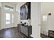 Bright foyer with a high ceiling, complemented by wood floors and an artistic console table at 32773 Tree Of Life Ave, Wesley Chapel, FL 33543