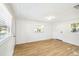A bedroom with bright white walls and light wood floors at 38638 2Nd Ave, Zephyrhills, FL 33542