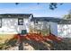 Backyard view of a home with a wooden deck and a new air conditioner at 38638 2Nd Ave, Zephyrhills, FL 33542