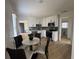 Charming eat-in kitchen features stainless steel appliances, white cabinetry, and modern finishes at 38638 2Nd Ave, Zephyrhills, FL 33542