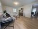 Bright living room boasts modern furnishings, hardwood flooring, and ample natural light at 38638 2Nd Ave, Zephyrhills, FL 33542