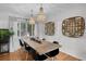 Charming dining room featuring wood table, chandelier, and decorative wall baskets at 4819 W Bay Villa Ave, Tampa, FL 33611