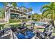 Serene backyard with a modern fire table, comfortable seating, a luxurious pool, and verdant greenery at 5004 S The Riviera, Tampa, FL 33609